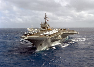 A port bow view of the aircraft carrier USS CONSTELLATION (CV-64) underway with various aircraft of the carrier's air wing parked on the flight deck-DPLA.jpeg